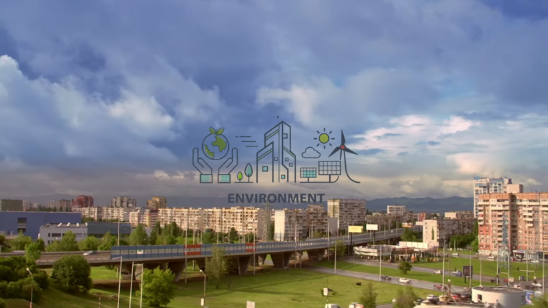  A Cityscape Featuring Apartment Buildings, Greenery, and A Bridge, Overlaid with Icons Representing Sustainability, Renewable Energy, and Environmental Care