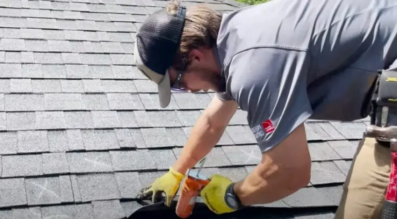 A man repairs a roof