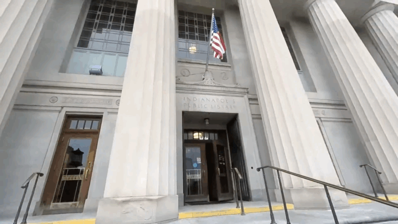 Entrance of Indianapolis Central Library with columns and an American flag