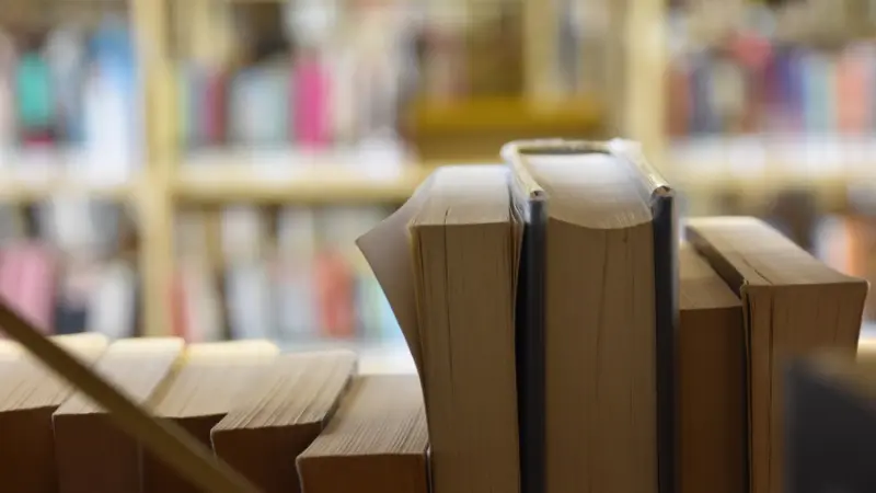 Close-up of books lined up on a shelf in an Indiana public library