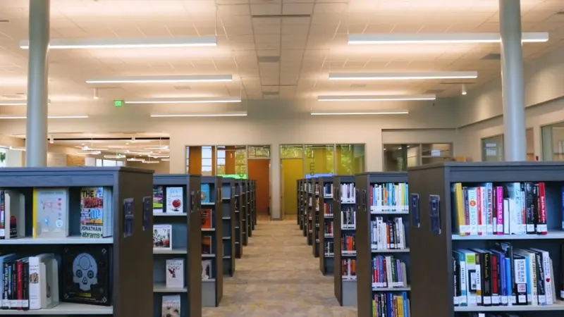 Rows of bookshelves inside Monroe County Public Library