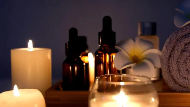 Soft candlelight reflects off oils and towels arranged for a calm visit to spa centers