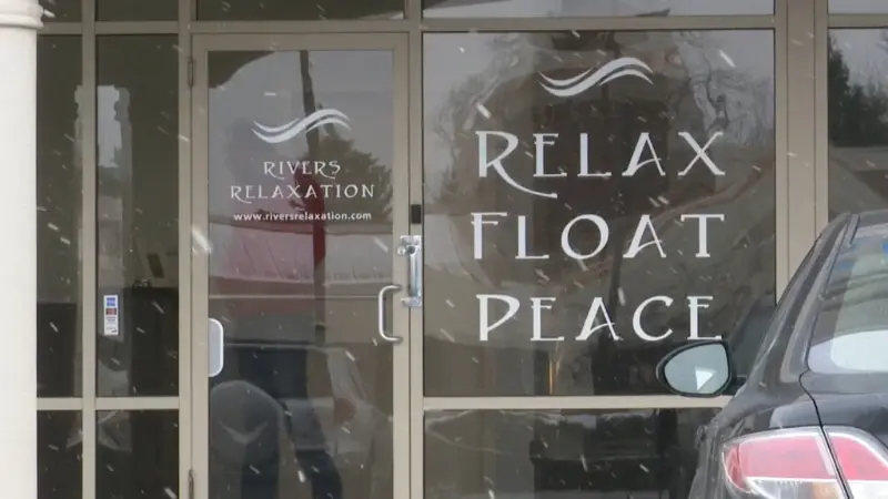 Entrance to Rivers Relaxation with glass doors showing the words relax, float, and peace