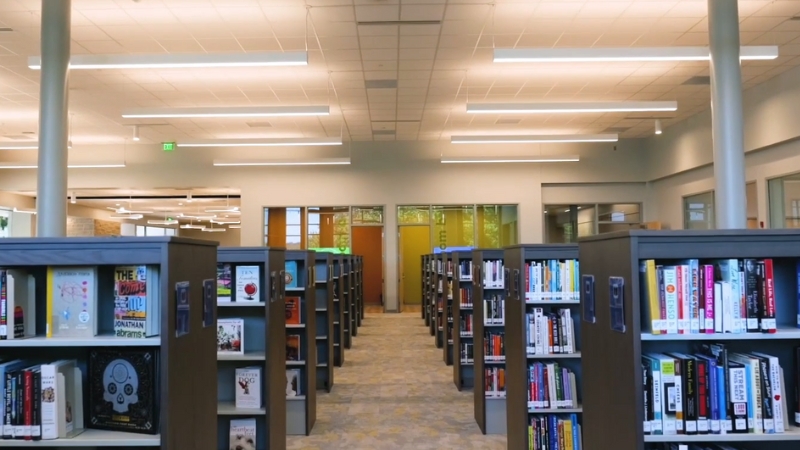 Rows of bookshelves inside Monroe County Public Library